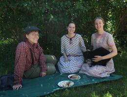 interpreters sitting in front of a lilac bush